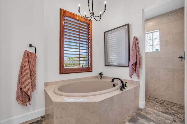 bathroom with separate shower and tub, a wealth of natural light, and a notable chandelier