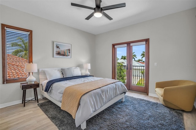 bedroom featuring access to outside, multiple windows, light hardwood / wood-style floors, and ceiling fan