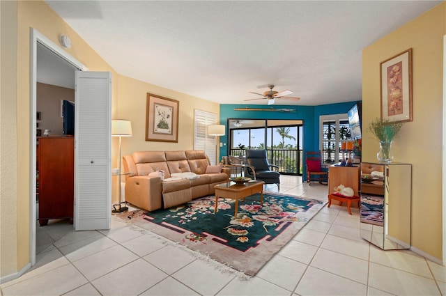 living room with ceiling fan and light tile patterned flooring