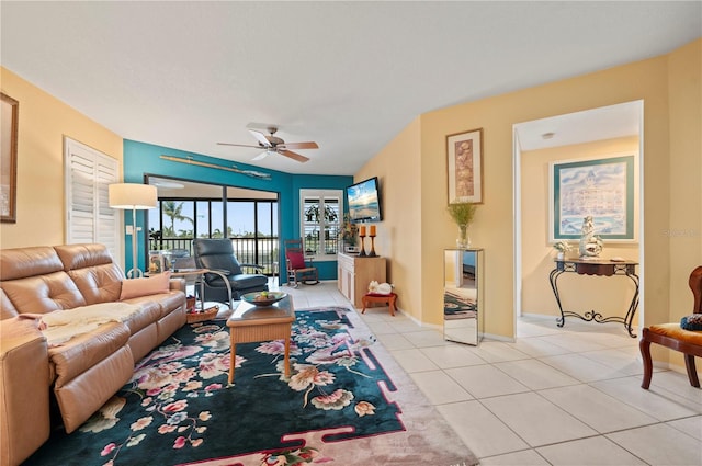 tiled living room featuring ceiling fan and lofted ceiling