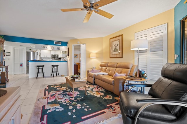 living room featuring light tile patterned floors and ceiling fan