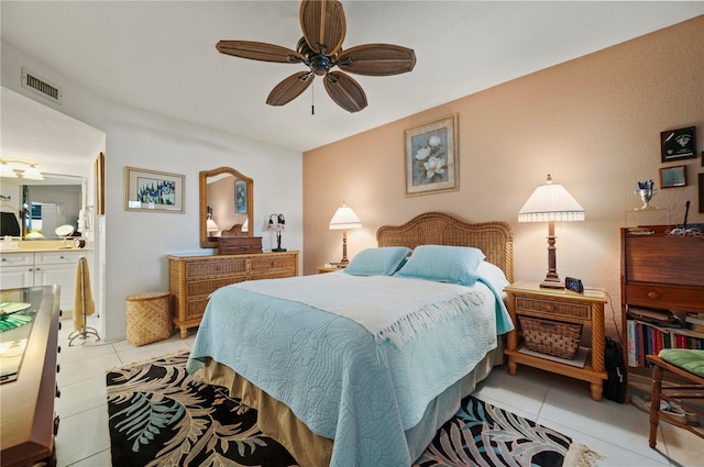 bedroom featuring ensuite bath, ceiling fan, and light tile patterned floors