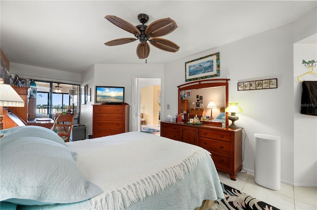 bedroom featuring access to exterior, ceiling fan, and light tile patterned floors