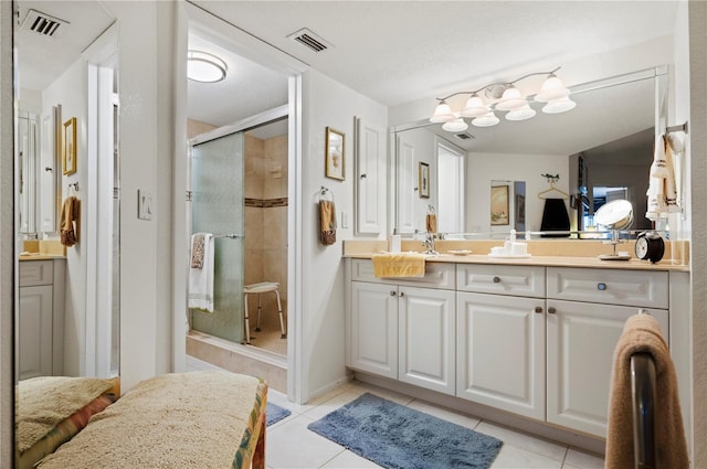 bathroom featuring tile patterned flooring, vanity, and a shower with shower door