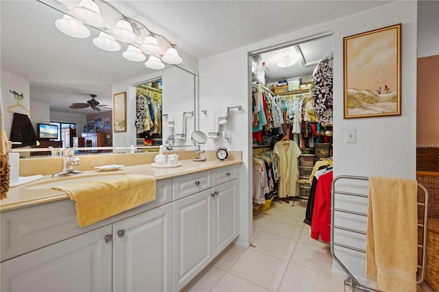 bathroom with tile patterned floors, ceiling fan, a textured ceiling, and vanity