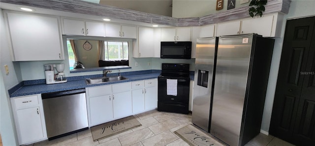 kitchen with sink, light tile patterned floors, black appliances, and white cabinets