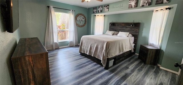 bedroom featuring dark hardwood / wood-style flooring and ceiling fan