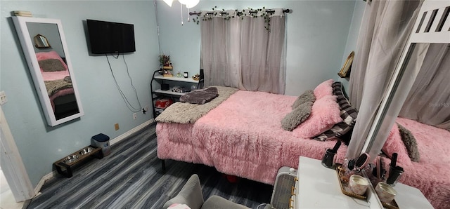 bedroom with dark wood-type flooring