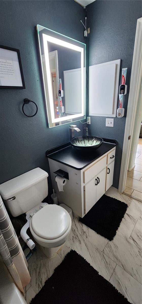 bathroom featuring vanity and toilet