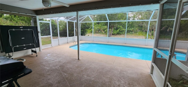 view of swimming pool with a patio and glass enclosure