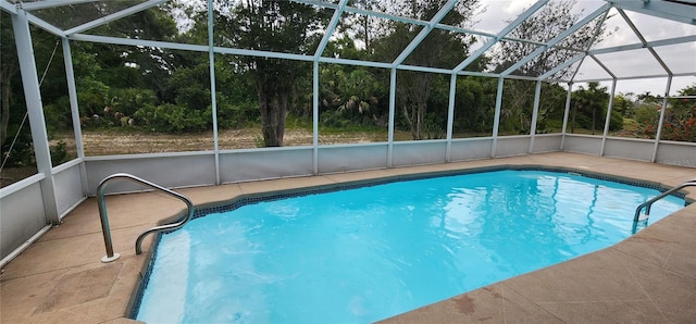 view of pool featuring a patio area and glass enclosure