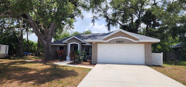 ranch-style home featuring a garage and a front yard