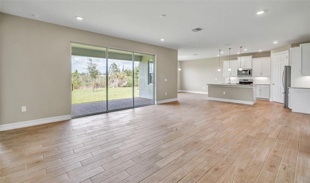 unfurnished living room featuring sink