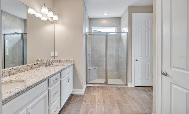 bathroom featuring walk in shower and vanity