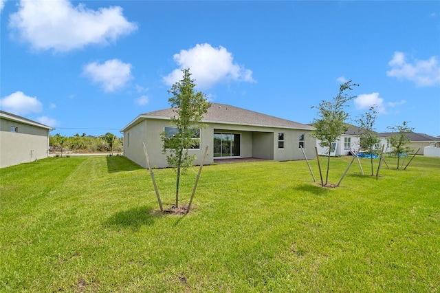 back of house featuring a yard