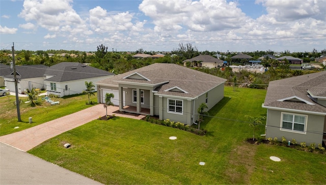 view of front of house with a garage and a front lawn