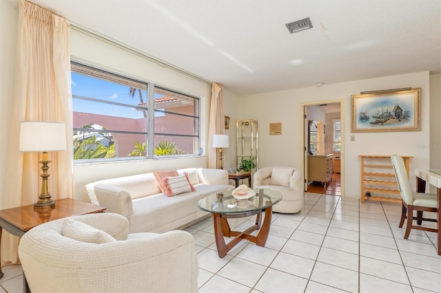 living room featuring light tile patterned floors and visible vents