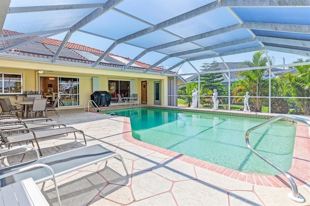 pool featuring a patio, grilling area, and a lanai