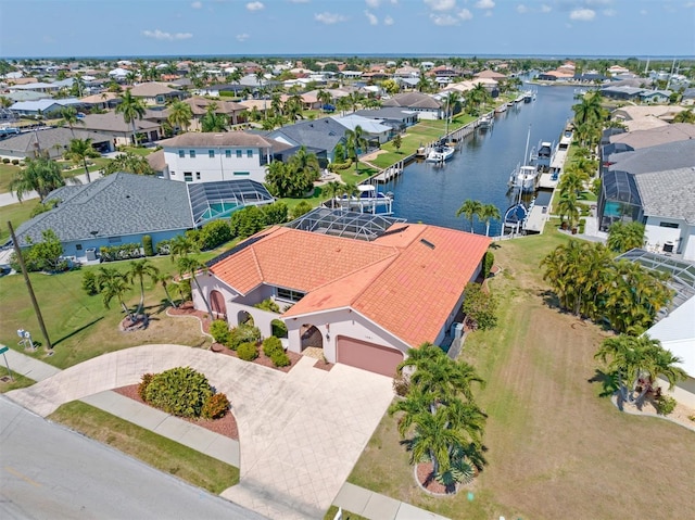 drone / aerial view with a water view and a residential view