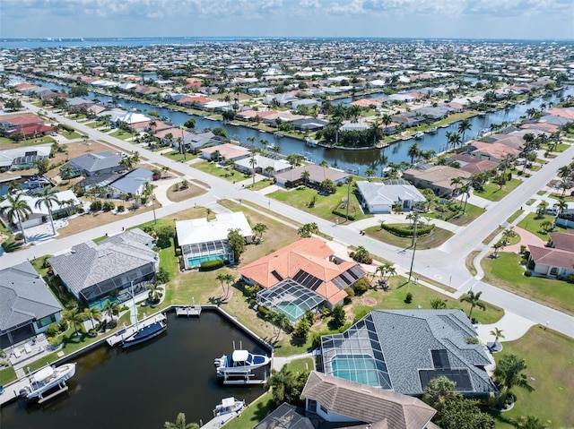 birds eye view of property featuring a water view and a residential view