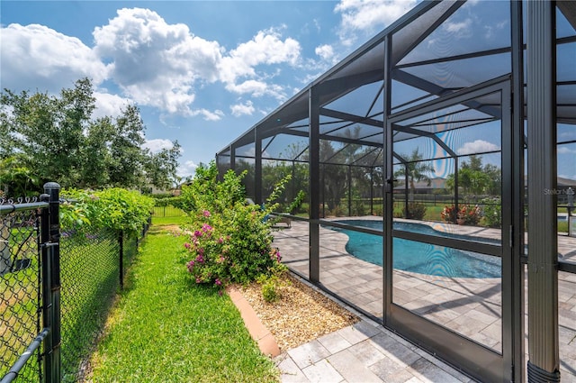 view of swimming pool with a yard, a lanai, and a patio area