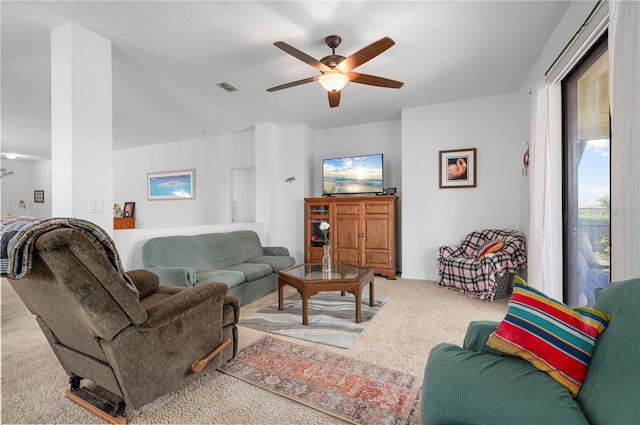 living room featuring carpet and ceiling fan