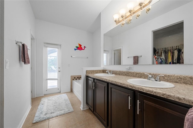 bathroom featuring dual vanity, tile floors, and a bath