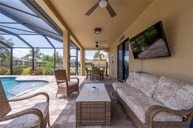 view of patio with an outdoor hangout area, glass enclosure, and ceiling fan