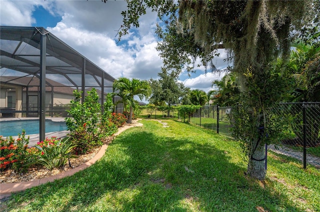 view of yard with glass enclosure