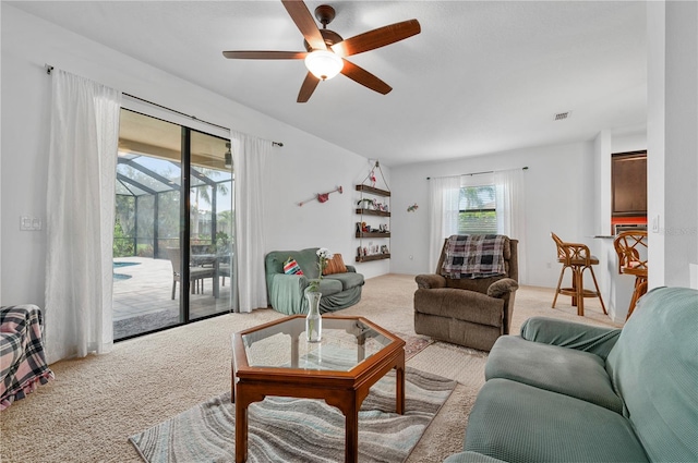 carpeted living room featuring ceiling fan