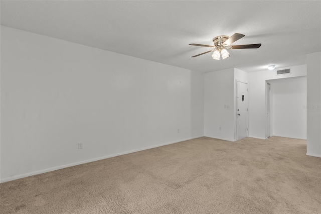 unfurnished room featuring light colored carpet and ceiling fan