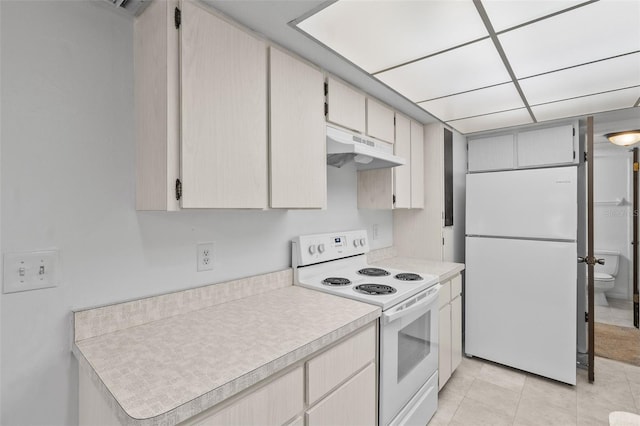 kitchen with white appliances and light tile patterned floors