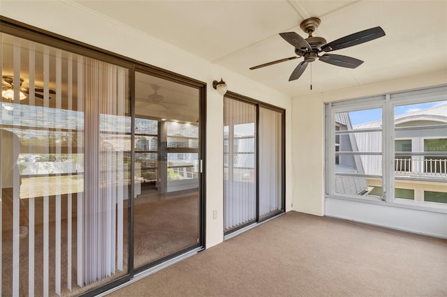 unfurnished sunroom featuring ceiling fan