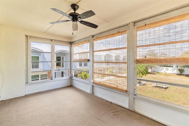 unfurnished sunroom featuring plenty of natural light and ceiling fan