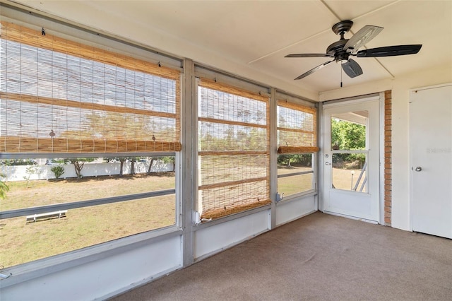 unfurnished sunroom featuring ceiling fan