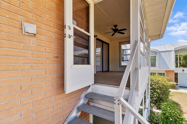 view of exterior entry featuring ceiling fan