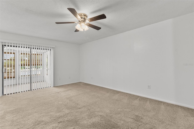 carpeted empty room with ceiling fan and a textured ceiling