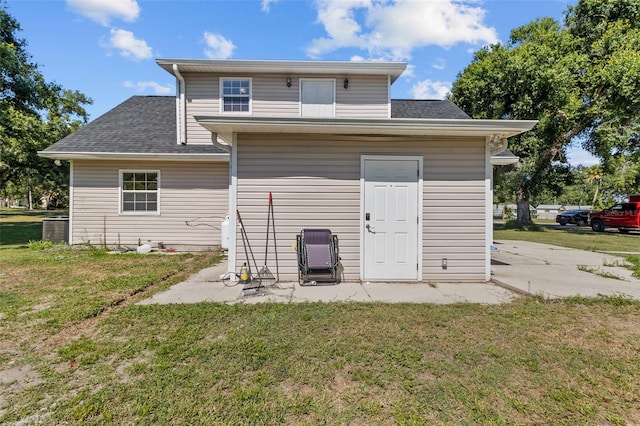 rear view of property featuring a yard