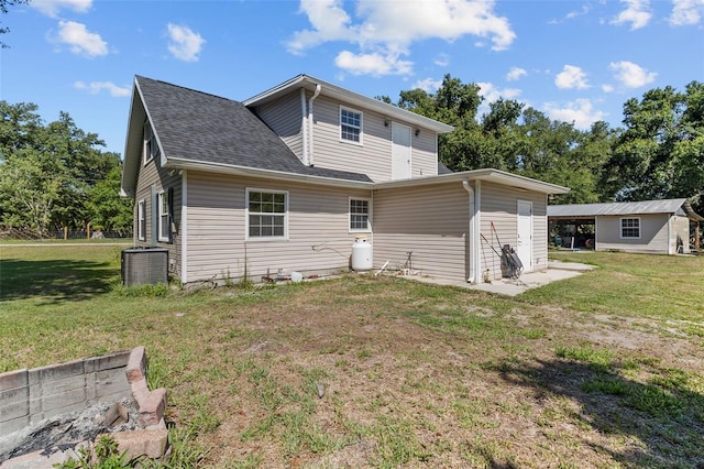 rear view of property with a lawn