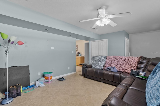 tiled living room featuring ceiling fan