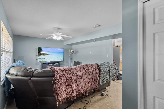 living room with ceiling fan and light tile patterned floors