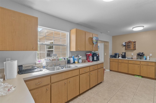 kitchen featuring sink, light tile patterned flooring, and light brown cabinets