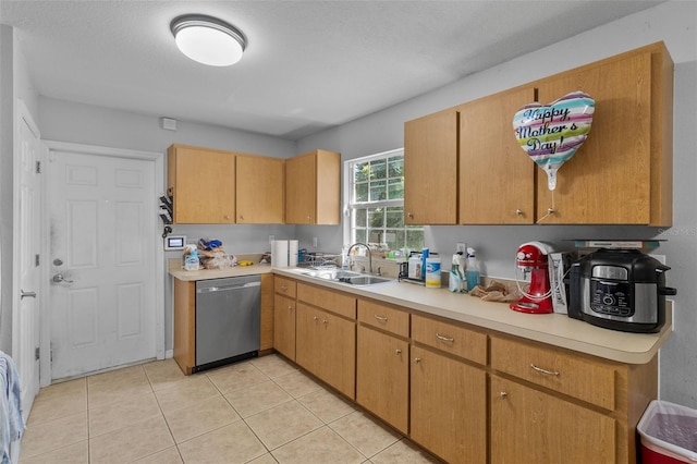 kitchen featuring dishwasher, light tile patterned floors, and sink