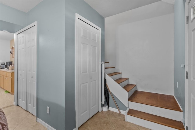 stairway with tile patterned floors