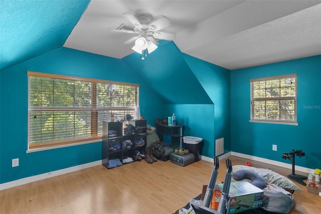 interior space featuring ceiling fan, plenty of natural light, a textured ceiling, and hardwood / wood-style flooring