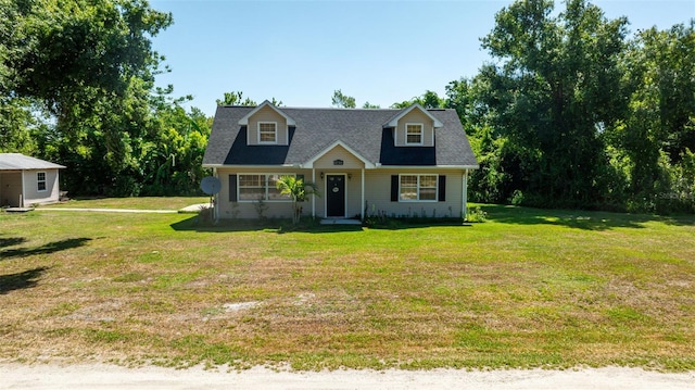 cape cod house with a front yard