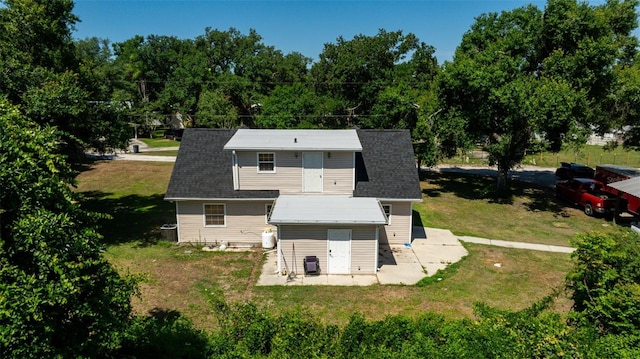 rear view of property with a yard