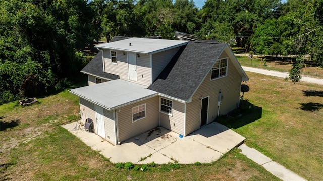 back of property with a lawn, cooling unit, and a patio