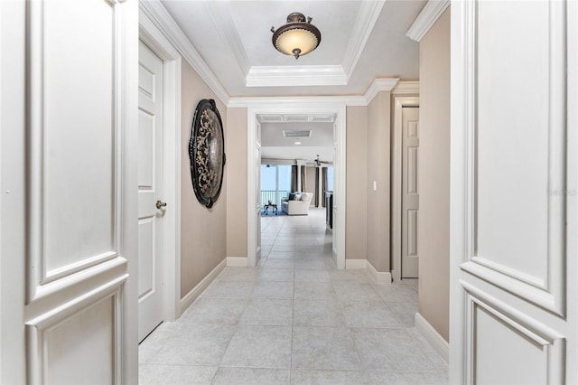 corridor featuring ornamental molding and light tile patterned flooring