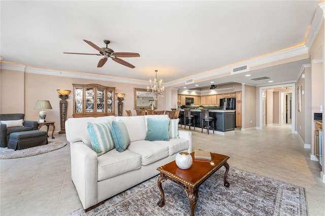 living room featuring ceiling fan with notable chandelier, light tile patterned floors, and crown molding